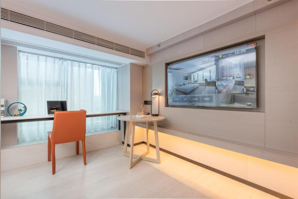 TV a/nebo společenská místnost v ubytování ONESS Executive Hotel Guangzhou Huangpu Luogang
