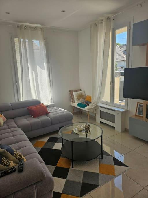 un salon avec un canapé et une table basse dans l'établissement Maison entière avec terrasse, à Champigny-sur-Marne