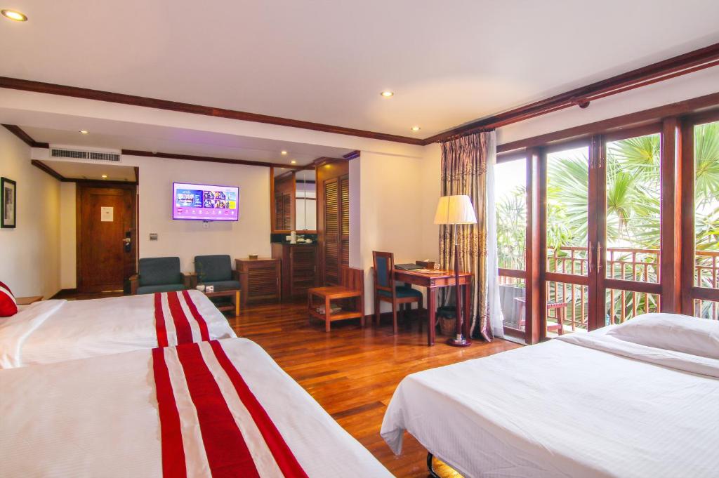 Postel nebo postele na pokoji v ubytování Cheathata CTS Hotel Siem Reap