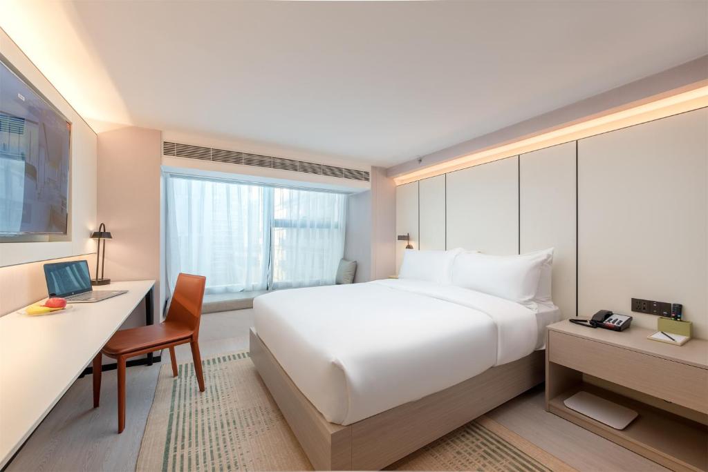 Postel nebo postele na pokoji v ubytování ONESS Executive Hotel Guangzhou Huangpu Luogang