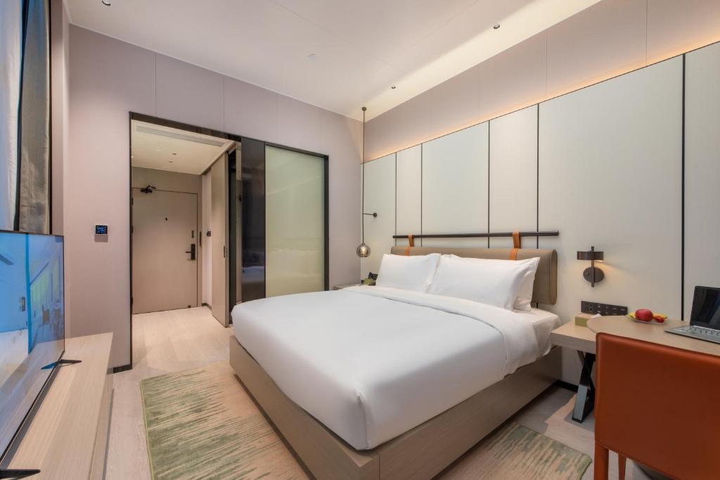 Postel nebo postele na pokoji v ubytování ONESS Executive Hotel Guangzhou Huangpu Luogang
