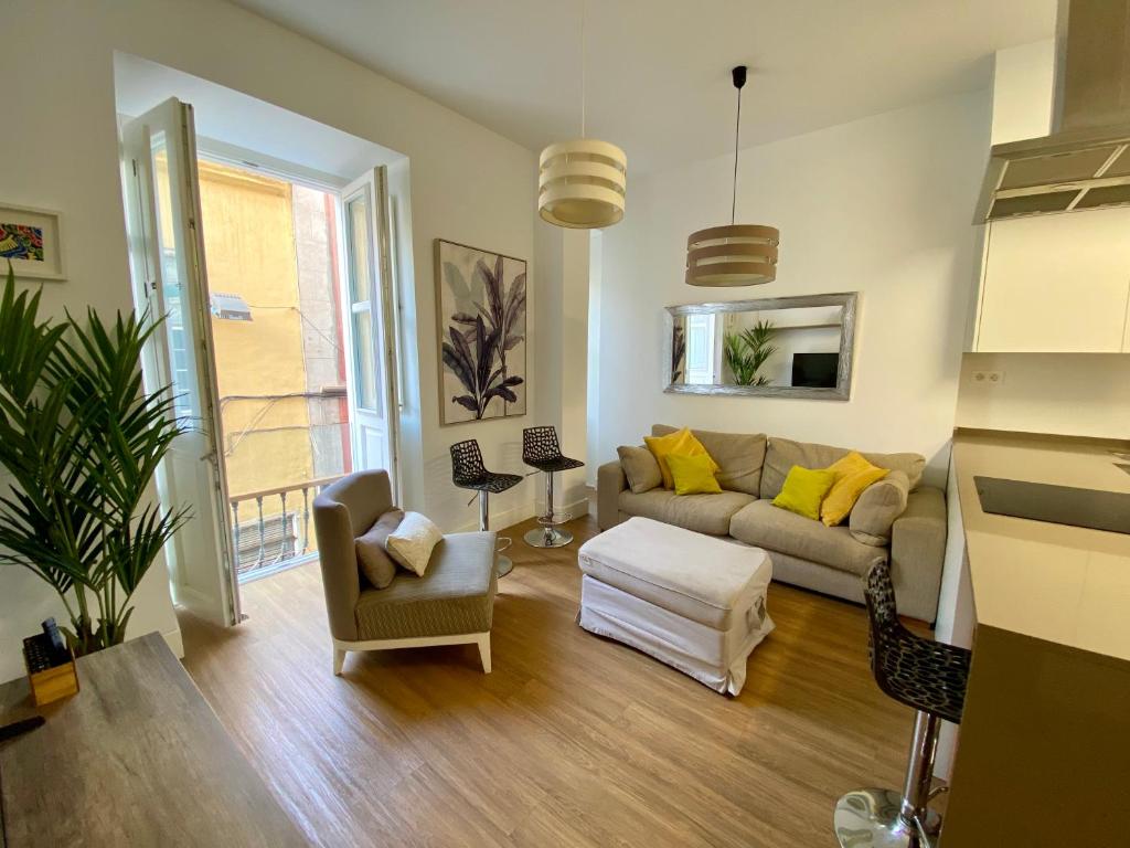 a living room with a couch and a chair at Suite Beethoven in Santa Cruz de Tenerife