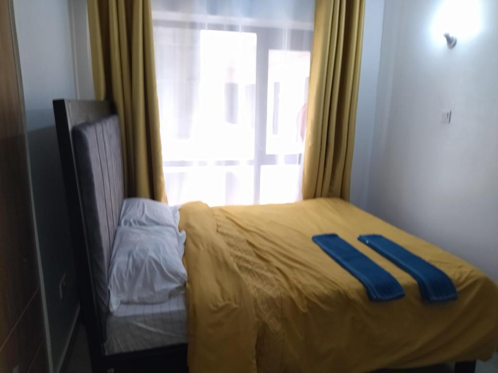Postel nebo postele na pokoji v ubytování Tsavo Studio Fedha