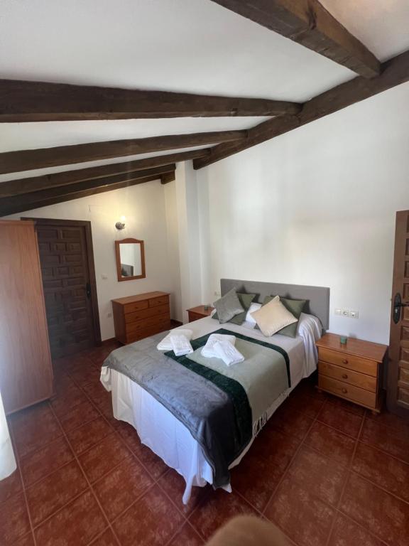 a bedroom with a large bed in a room at Casa Pancho in Zahara de la Sierra