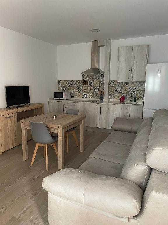 a living room with a couch and a table at Apartamentos 7 puentes sierra Cazorla Casa Ciprés in Burunchel