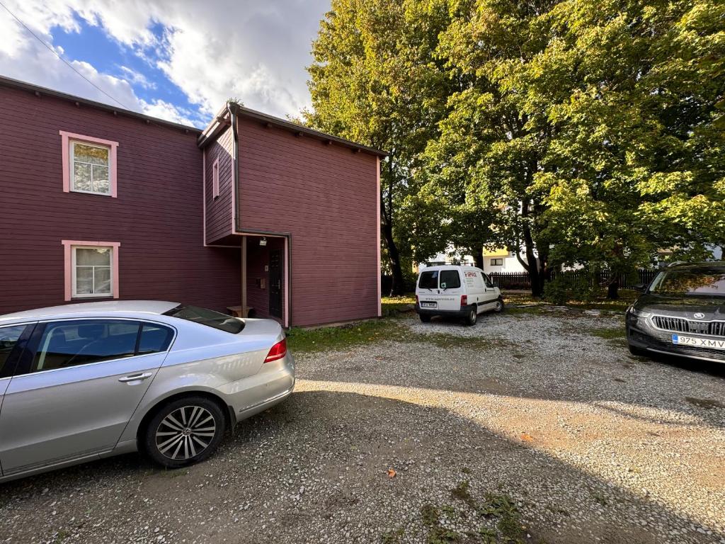 a car parked in a parking lot next to a house at Tallinn Downtown 1BR apartment with parking in Tallinn