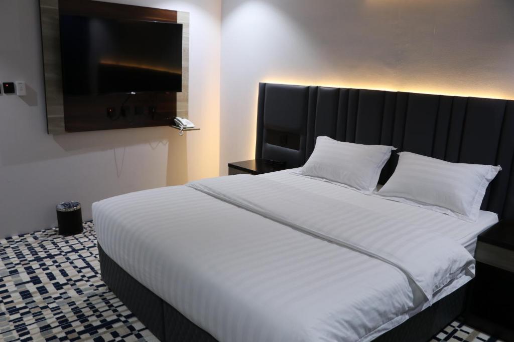 Postel nebo postele na pokoji v ubytování فندق قمم بارك Qimam Park Hotel 4