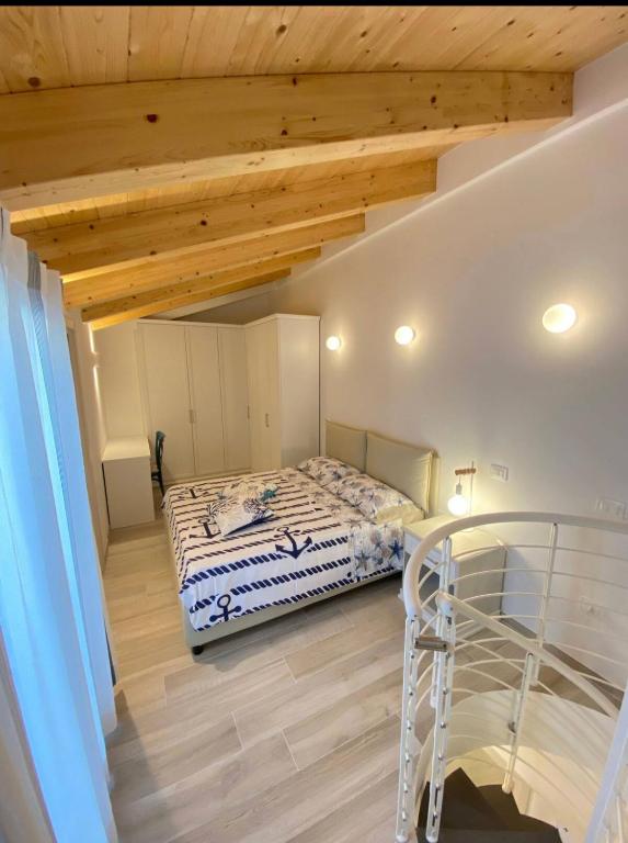 a bedroom with a bed and a wooden ceiling at Casa Vacanze Cimo Marine Style in Civitanova Marche