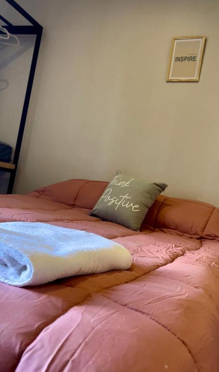 a bed with a pillow on top of it at Ushuaia Suites Connect Point 2 in Ushuaia