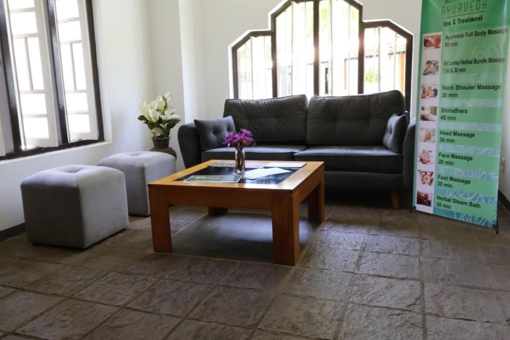 a living room with a couch and a coffee table at Handagedara Resort & Spa in Mirissa