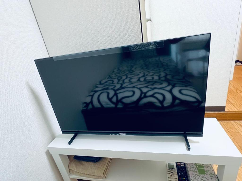 TV a/nebo společenská místnost v ubytování ビアン国立