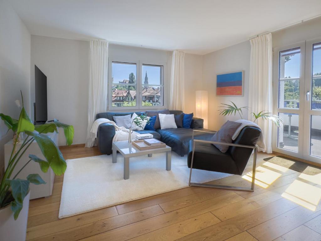 un soggiorno con un divano blu e un tavolo di Apartment with Mattress in Living Room a Berna