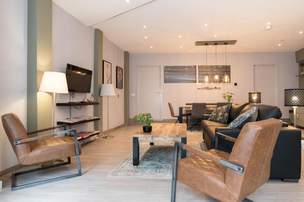 a living room with a couch and a table at Relaxed Apartments Haarlem in Haarlem
