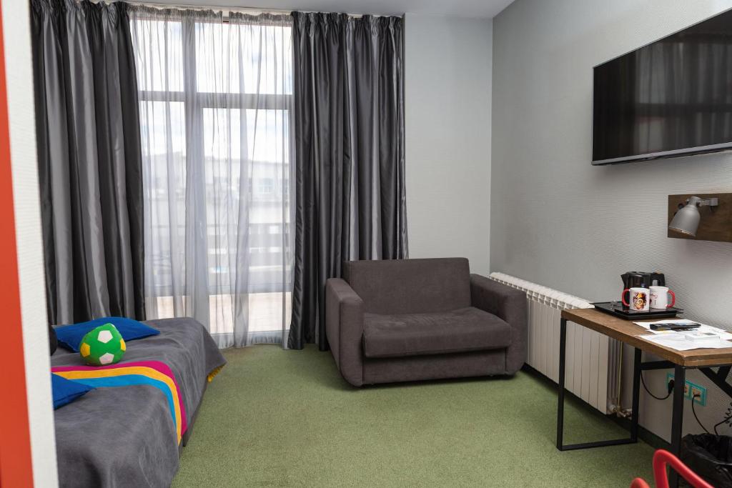 TV a/nebo společenská místnost v ubytování Emigrand Art Hotel