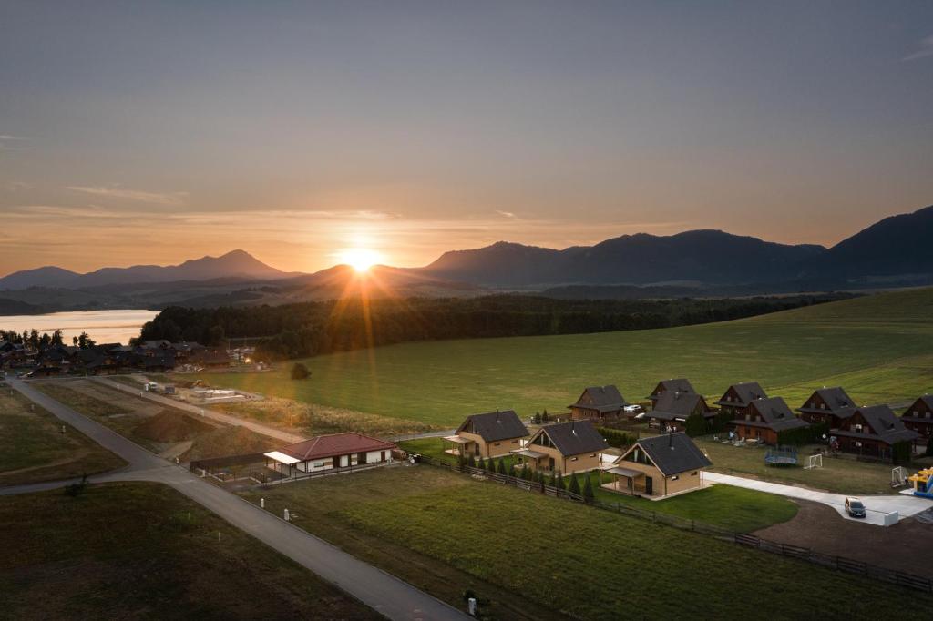 an aerial view of a village with houses and the sunset at Forest360 in Liptovský Mikuláš