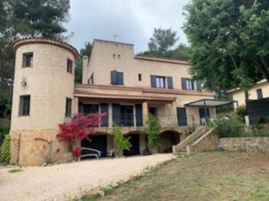 a large stone house with a yard in front of it at La Villa Lou Castel in Sanary-sur-Mer