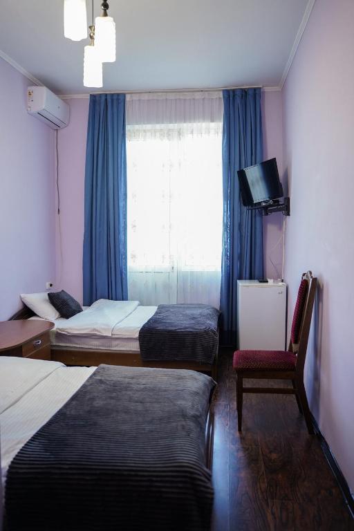 Postel nebo postele na pokoji v ubytování Europa Hotel-Kutaisi