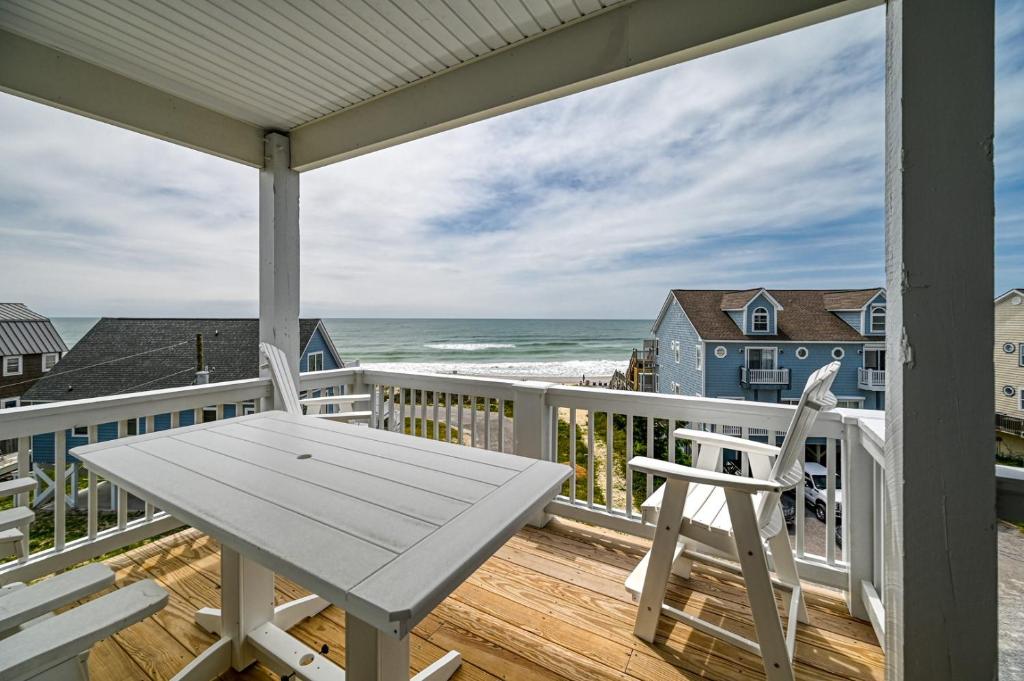 een veranda met een witte tafel en stoelen en de oceaan bij Unobstructed Ocean Views - Hot Tub - Sandy Path to Beach in North Topsail Beach