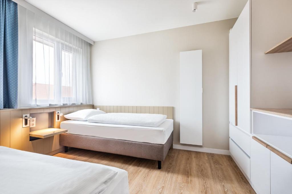Postel nebo postele na pokoji v ubytování BEECH Resort Boltenhagen