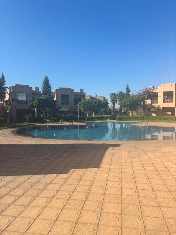 a swimming pool in the middle of a city at Beautiful cozy apartment with pool in Marrakesh