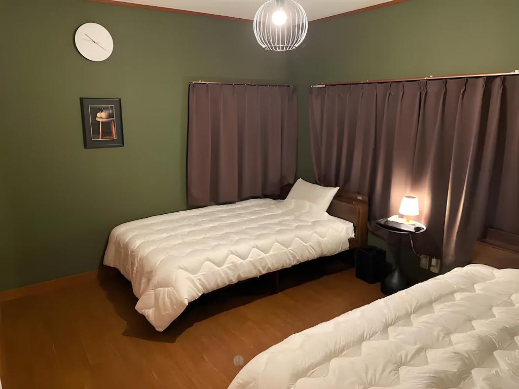 Postel nebo postele na pokoji v ubytování シュネール北軽井沢