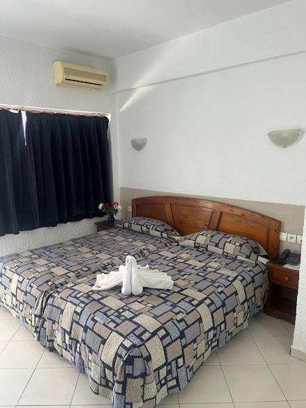 a bedroom with a bed with a robe on it at Studiotel Afoud in Agadir