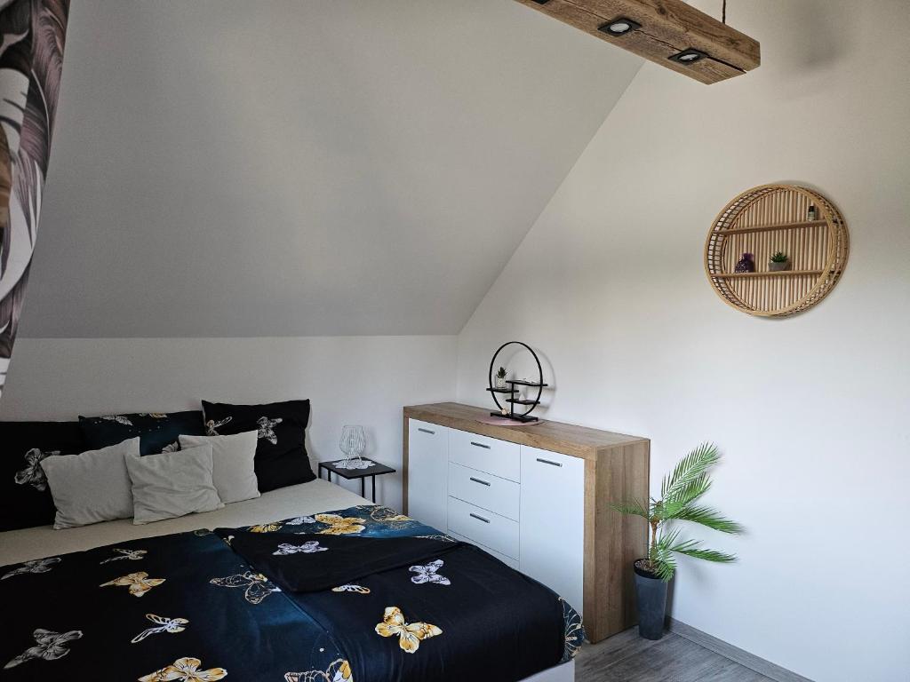a bedroom with a bed with a black comforter at Spokojny zakątek in Ustroń