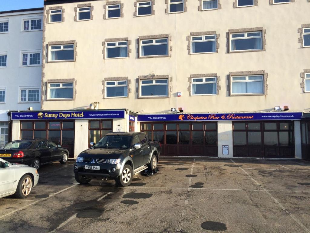 a car parked in a parking lot in front of a building at Sunny Days Hotel in Blackpool