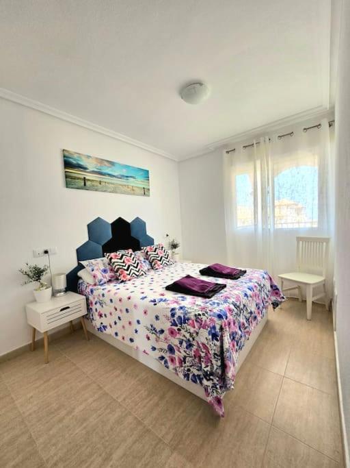 a bedroom with a large bed in a white room at Apartament Carina in Mar de Cristal