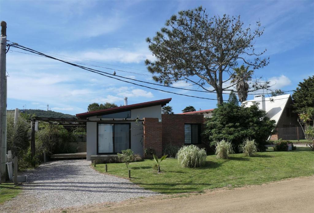 a brick house with a tree in the yard at Las Olas in Piriápolis