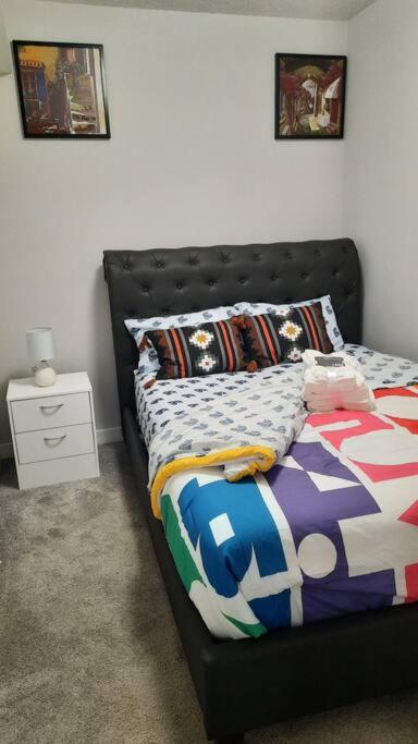 a bedroom with a bed with a black headboard at Carsonway Basement Suite in Edmonton
