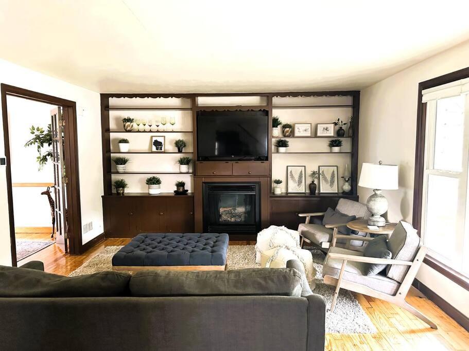 a living room with a couch and a fireplace at Wilson Street Home in Little Chute