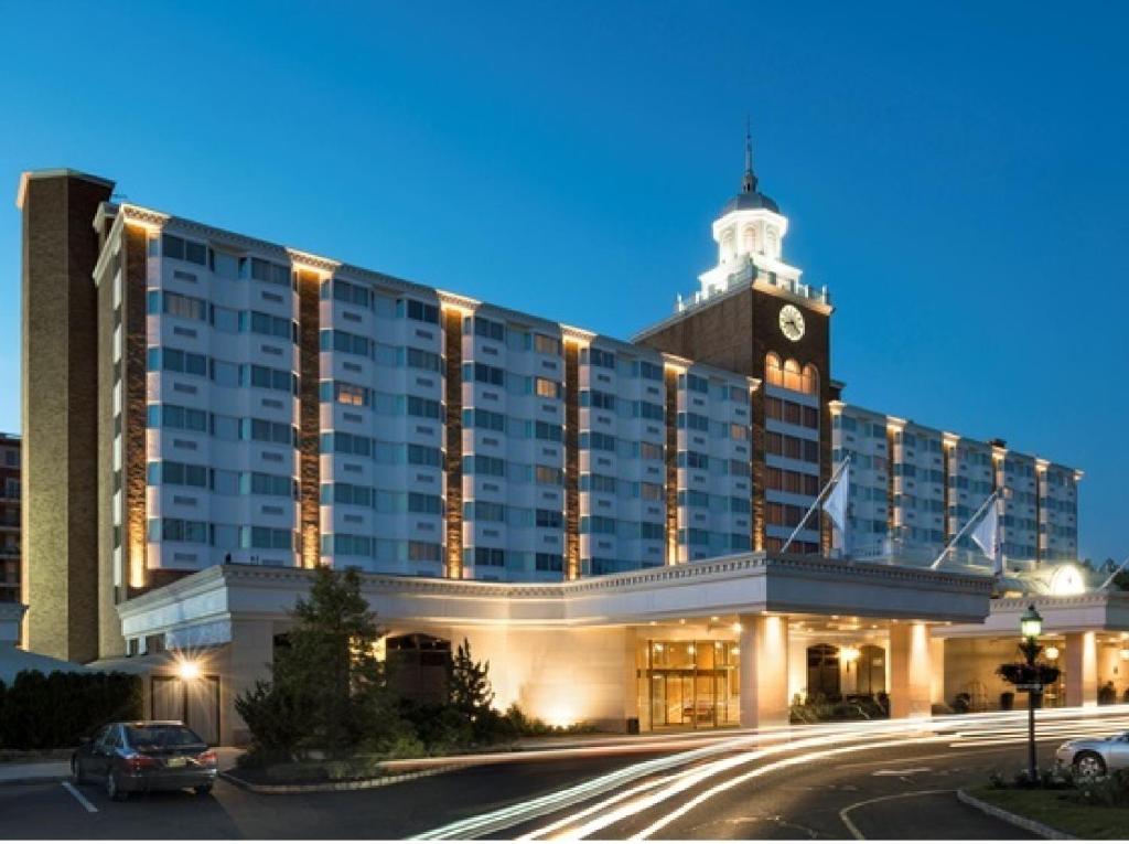 a large building with a clock tower on top of it at Garden City Hotel in Garden City