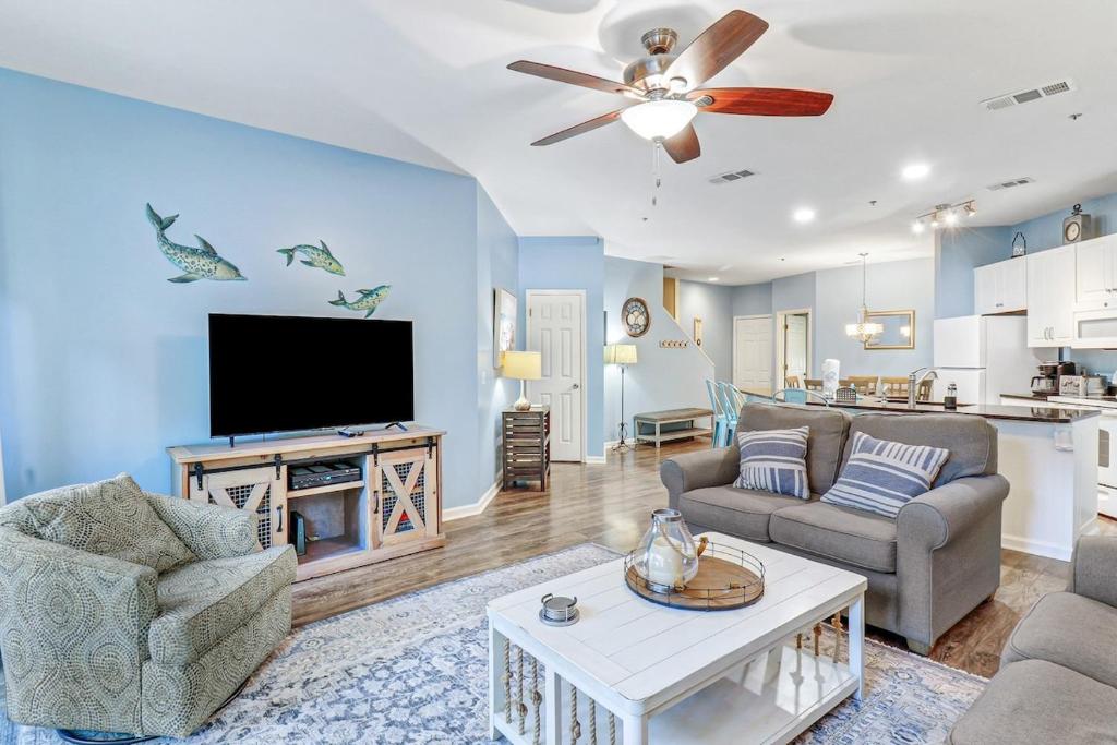 a living room with a couch and a tv at Lovely 3 Bed3 Bath Pet FriendlyVilla - Walk to the beach pools and tennis #75 Ocean Breeze in Hilton Head Island