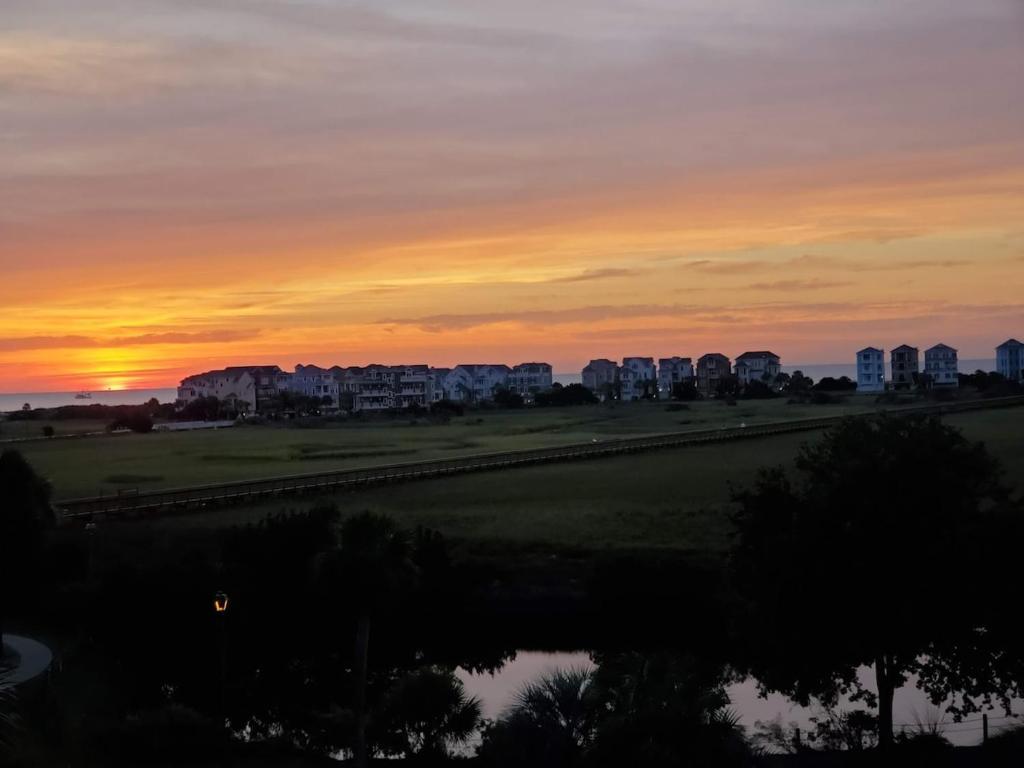 a sunset over a city with buildings in the background at Ocean View Good Vibes Villa 2 bed 2 bath in Hilton Head Island