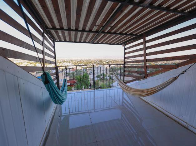 a hammock on a balcony with a view of the city at Jericho Palestine, Panorama Villa- View, Full Privacy & Pool in Jericho