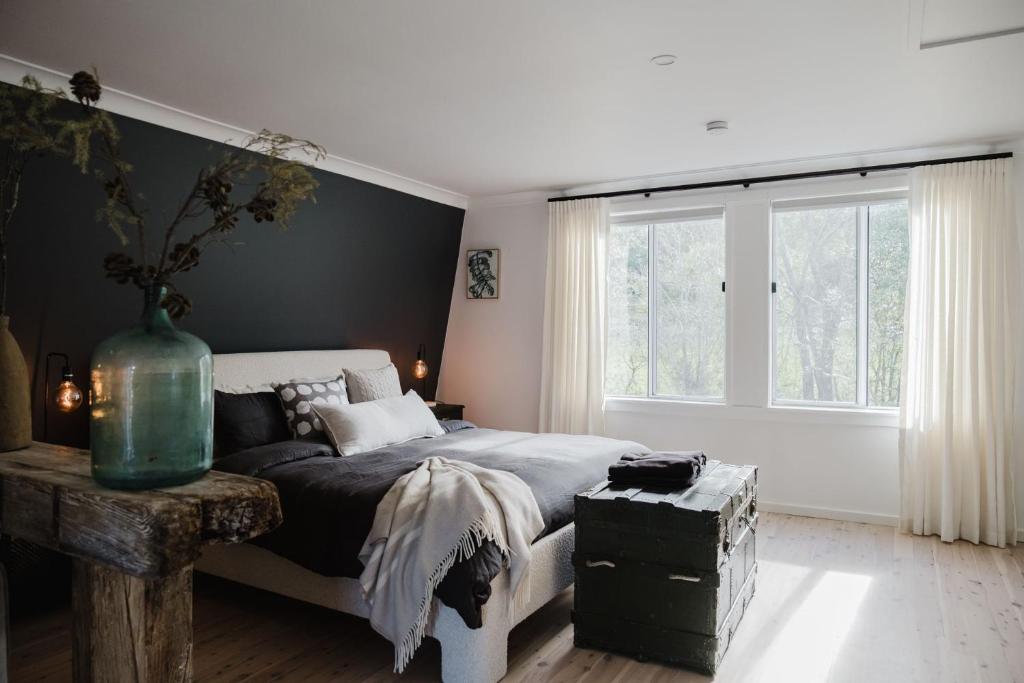 a bedroom with a bed and a large window at EKhaya - The Barn in Wattamolla