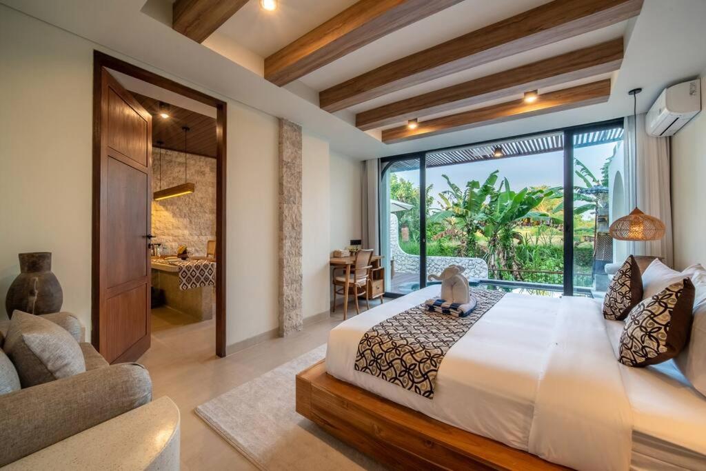 a bedroom with a large bed and a large window at Casa Tua - Hidden Ubud Gem Views in Ubud