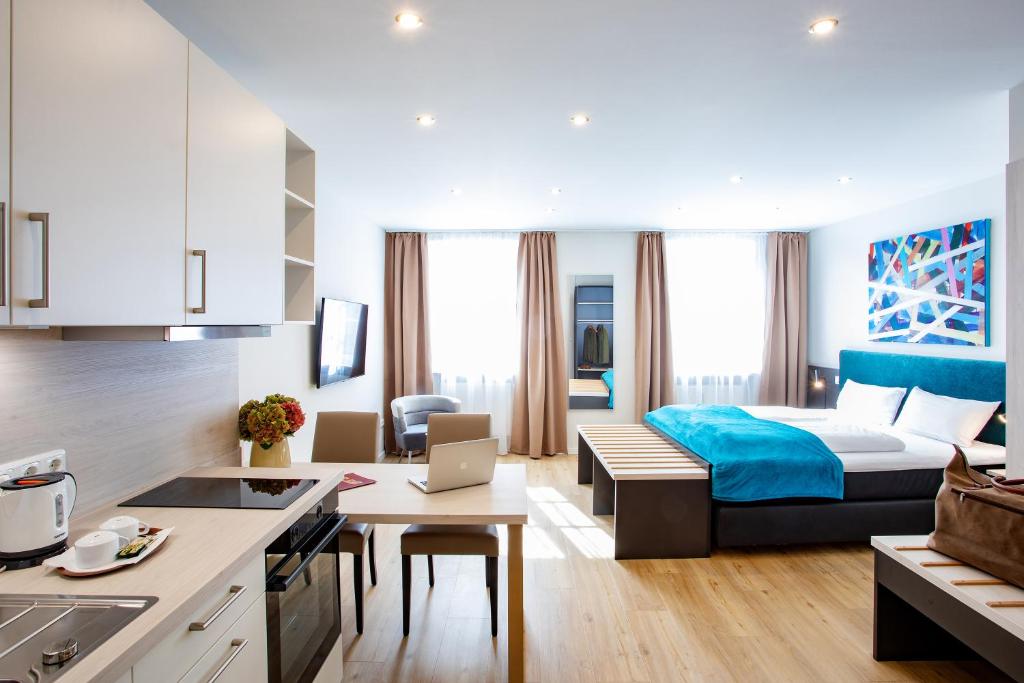 a kitchen and a living room with a bed in a room at Boardinghouse Hotel Münchner Hof Pfarrkirchen in Pfarrkirchen