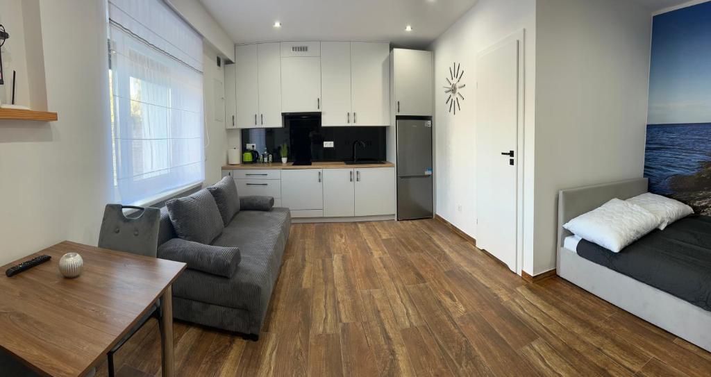 a living room with a couch and a table at Apartament Magdalenka in Strzelce Opolskie