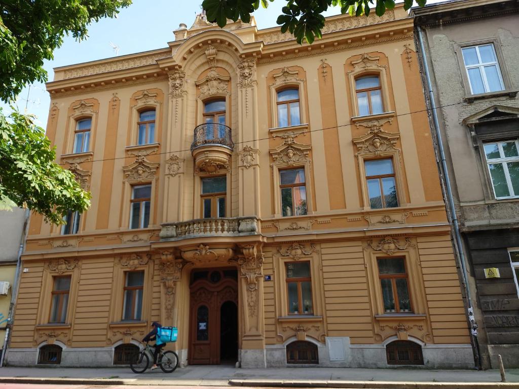 a person on a bike in front of a building at CENTRAL 2 ZAGREB in Zagreb