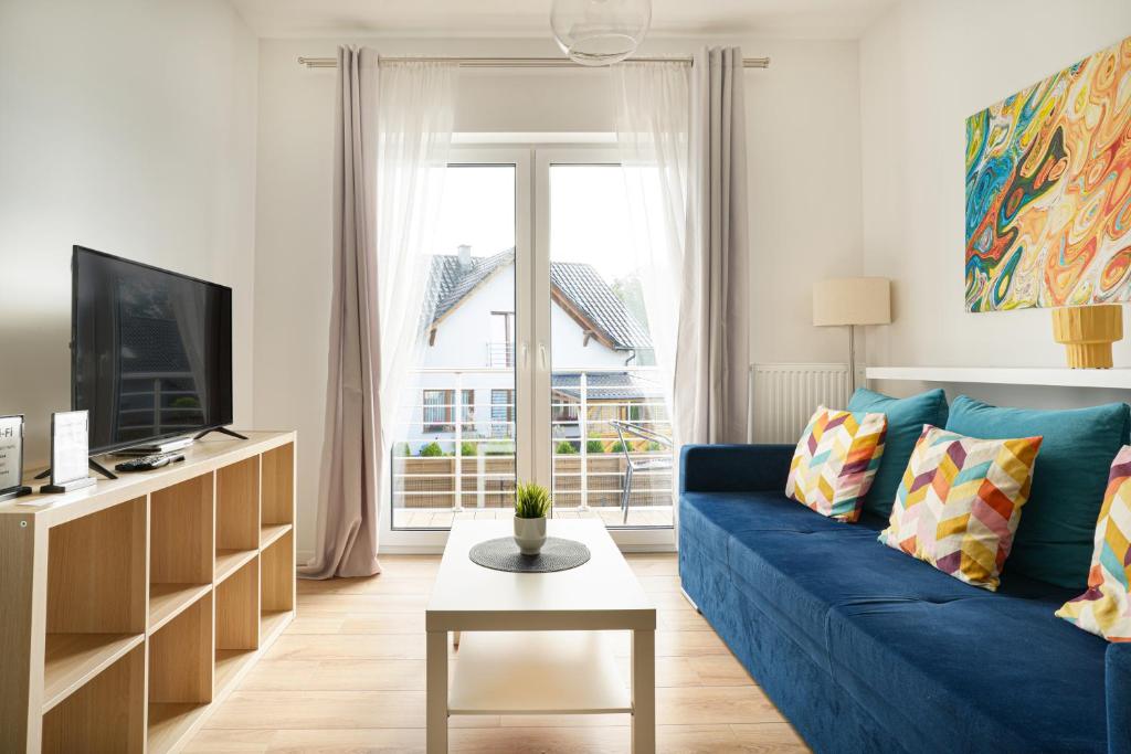 Televízia a/alebo spoločenská miestnosť v ubytovaní APARTAMENTY "LA VILLA" SUPERIOR II z dwoma sypialniami, balkonem, parkingiem, blisko centrum