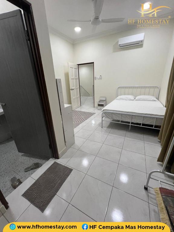 a bedroom with a bed and a walk in closet at HF Cempaka Mas 1 Homestay 2 Room in Kota Bharu