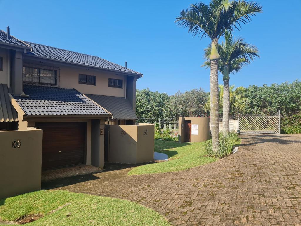 a house with a palm tree and a driveway at Riverglades 1 in Margate