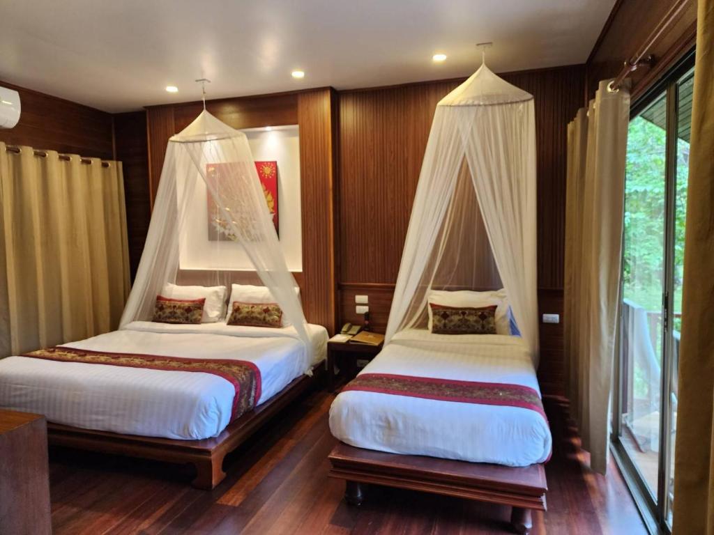 A bed or beds in a room at Phi Phi Natural Resort