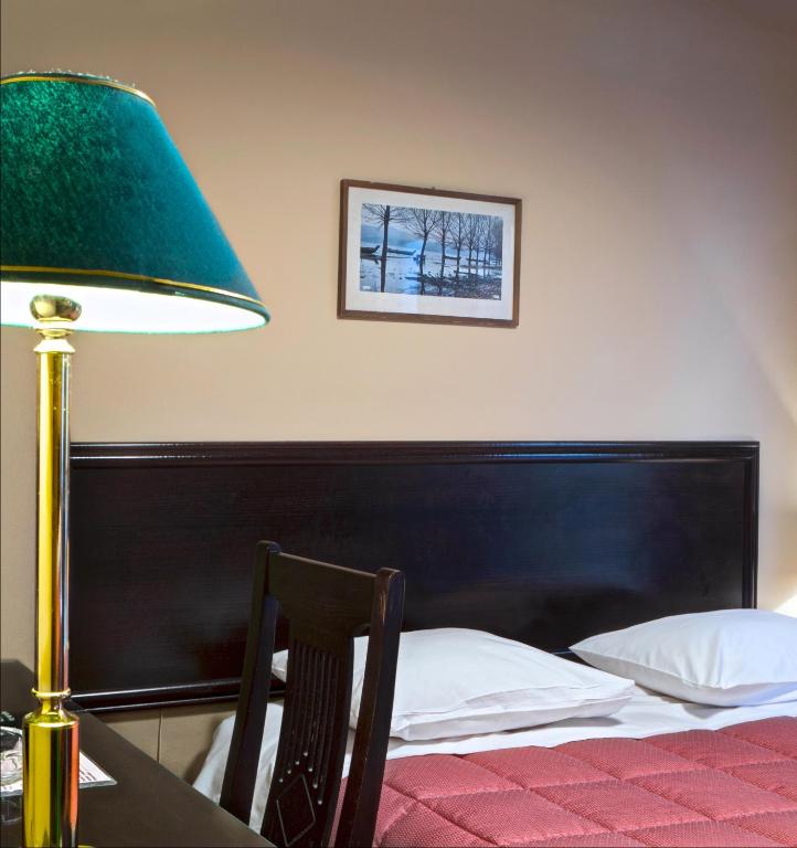 Postel nebo postele na pokoji v ubytování Nicola Hotel