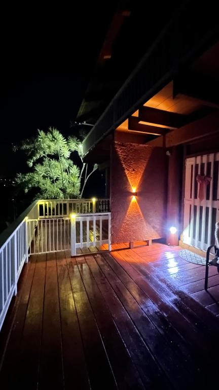 a deck at night with lights on the side of a building at Coffee Garden in Captain Cook