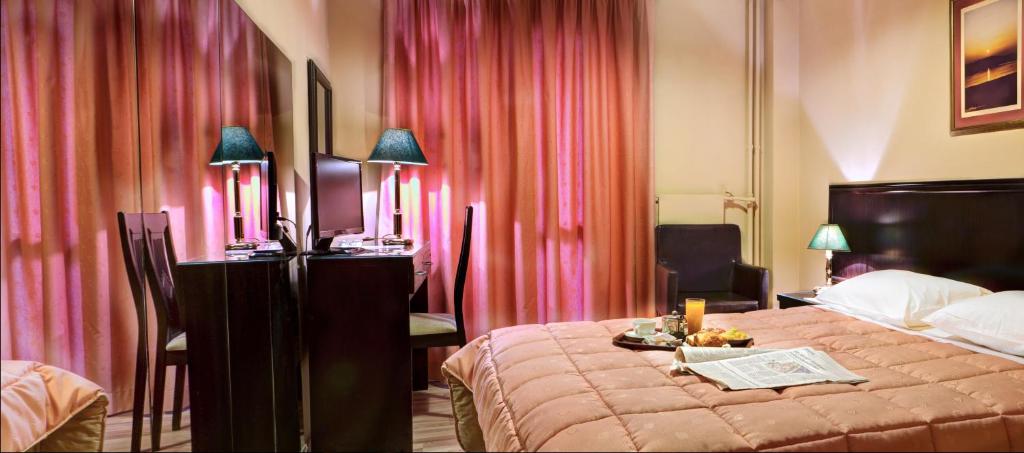 a hotel room with a bed and pink curtains at Nicola Hotel in Athens
