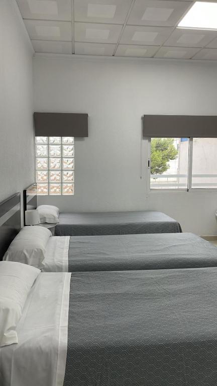 Postel nebo postele na pokoji v ubytování Hostal Kaizen