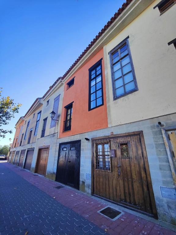a building with wooden doors on a street at Casa Cincilia in Chinchilla de Monte Aragón